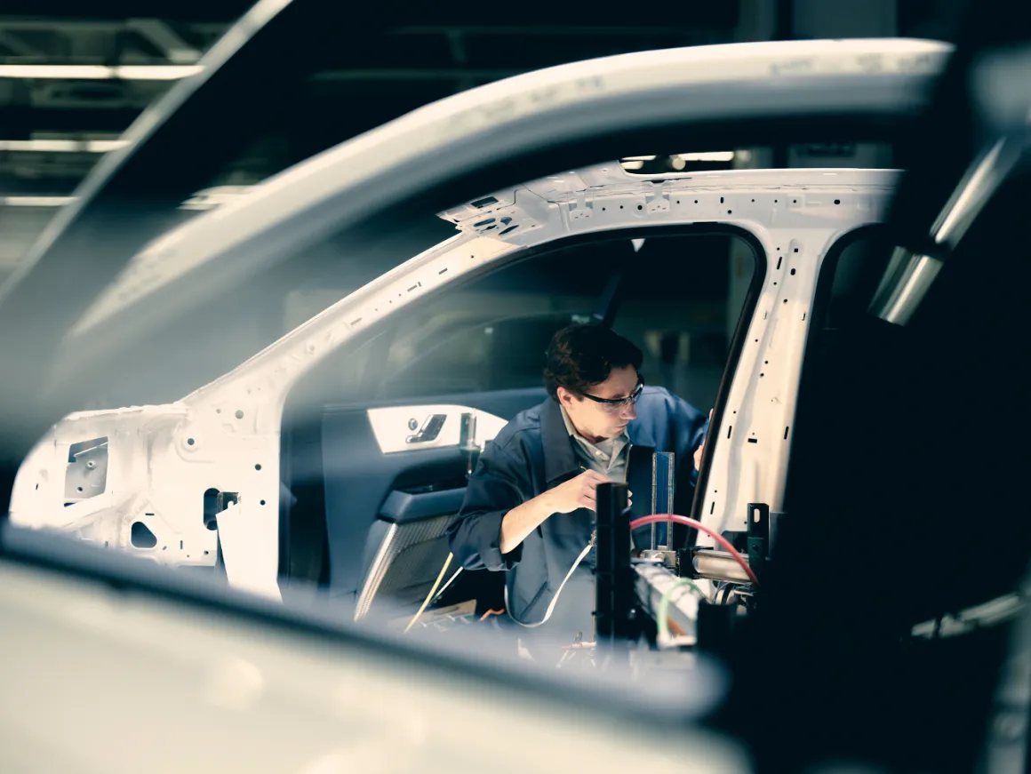 An operator fitting components inside a vehicle body