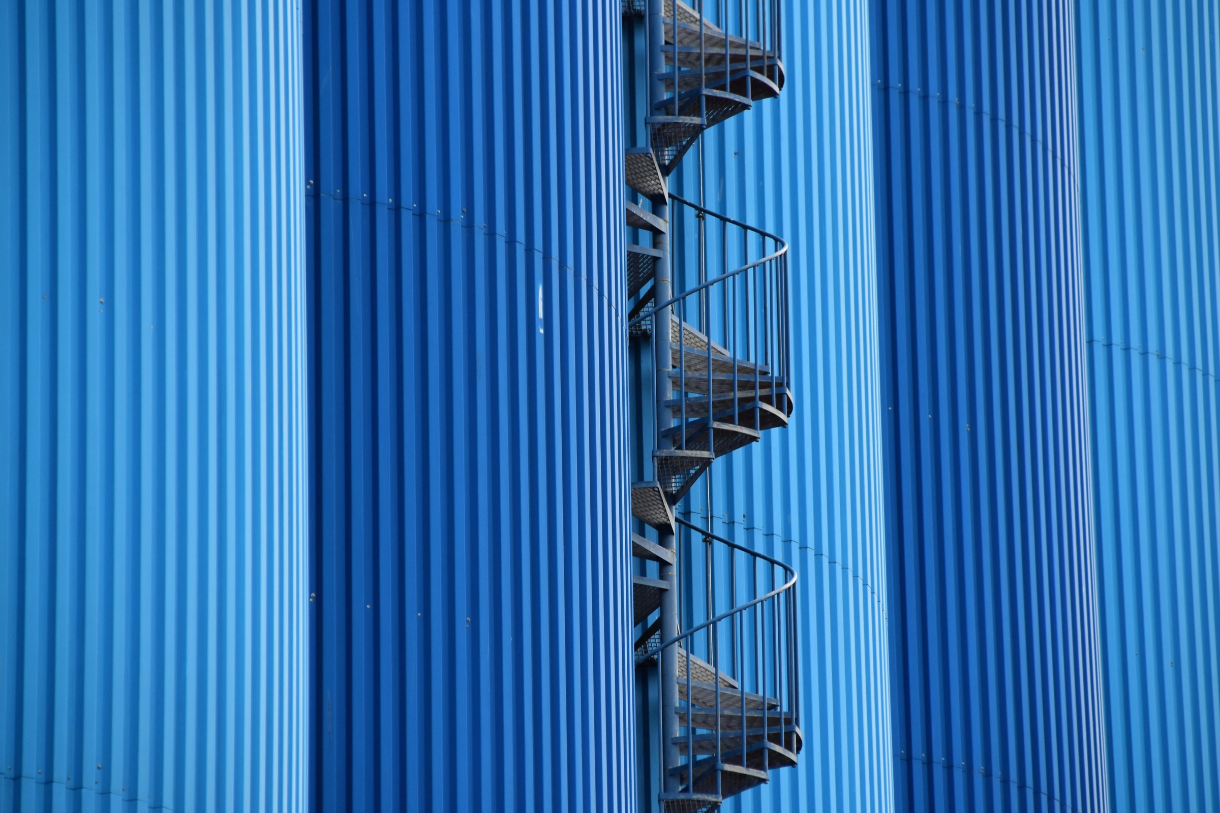 Blue corrugated silo cladding with a spiral stair